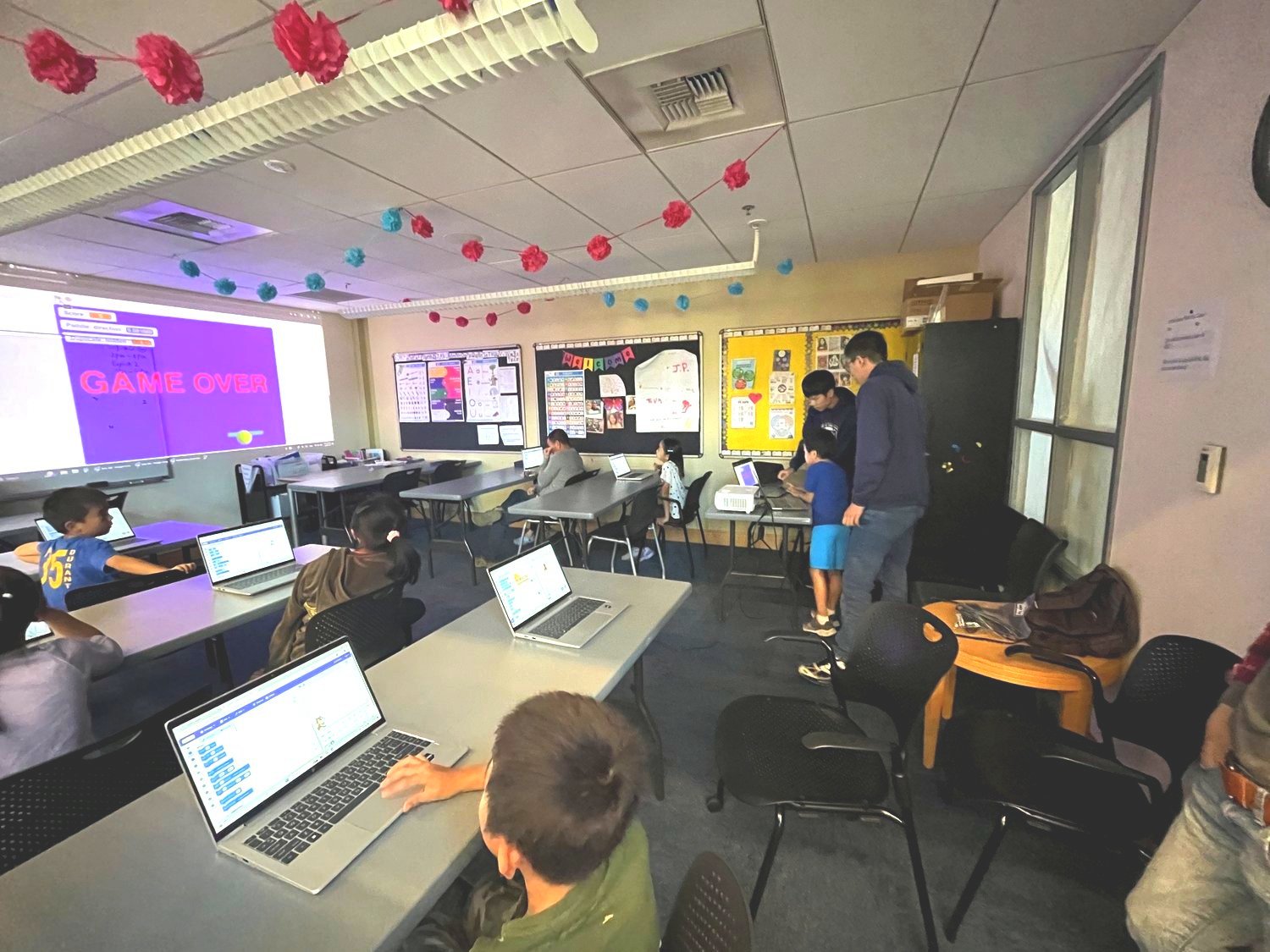 Participants building games in Scratch